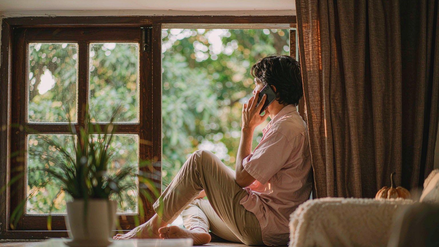 Adult on a video call with an aging parent, representing distant caregiving connection